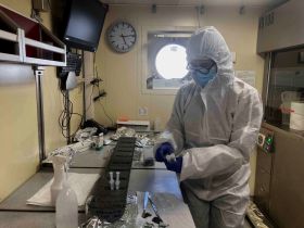 IOW Phytoplankton ecologist Anke Kremp in protective clothing taking samples from a Baltic Sea sediment core